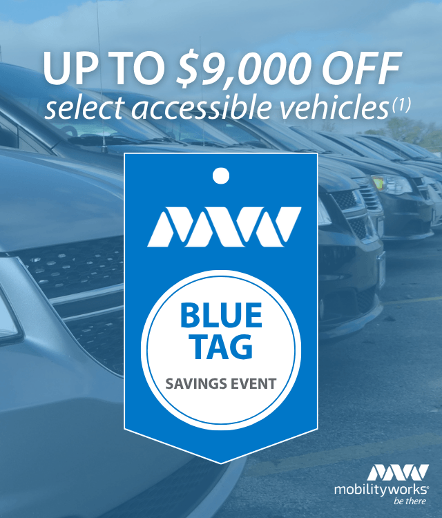 A row of accessible vehicles with a sign stating Up to $9,000 off select accessible vehicles and a Blue Tag Savings Event badge.