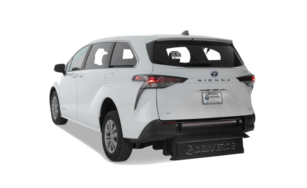 Rear view of a white Toyota Sienna minivan with a BraunAbility conversion ramp extended from the back for wheelchair accessibility.