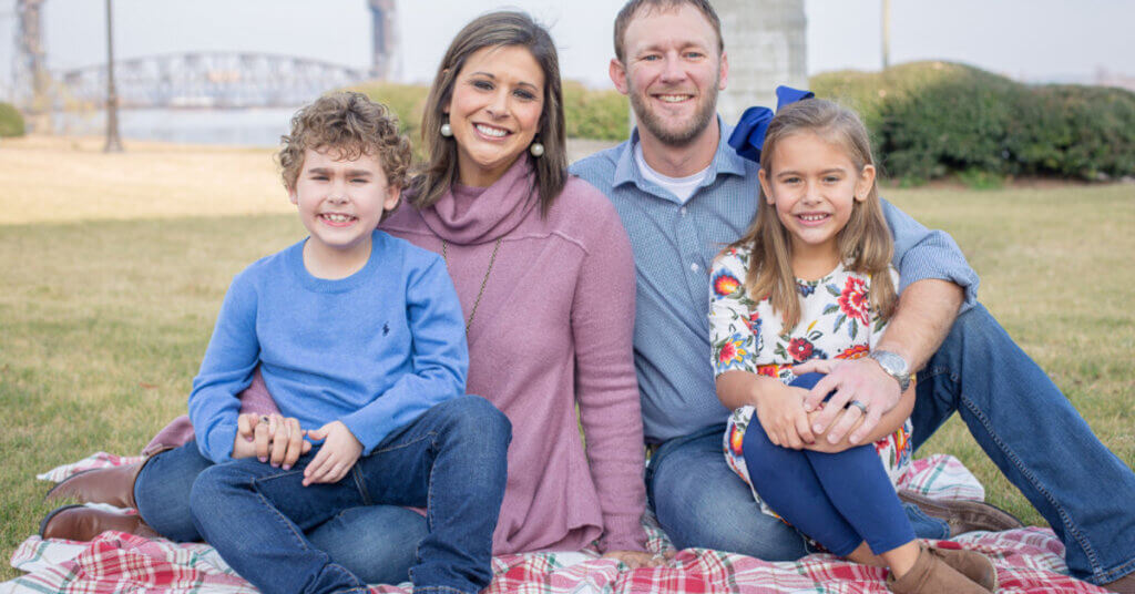 10 yr old MDA Ambassador Ethan LyBrand and his family sitting on blanket outdoors