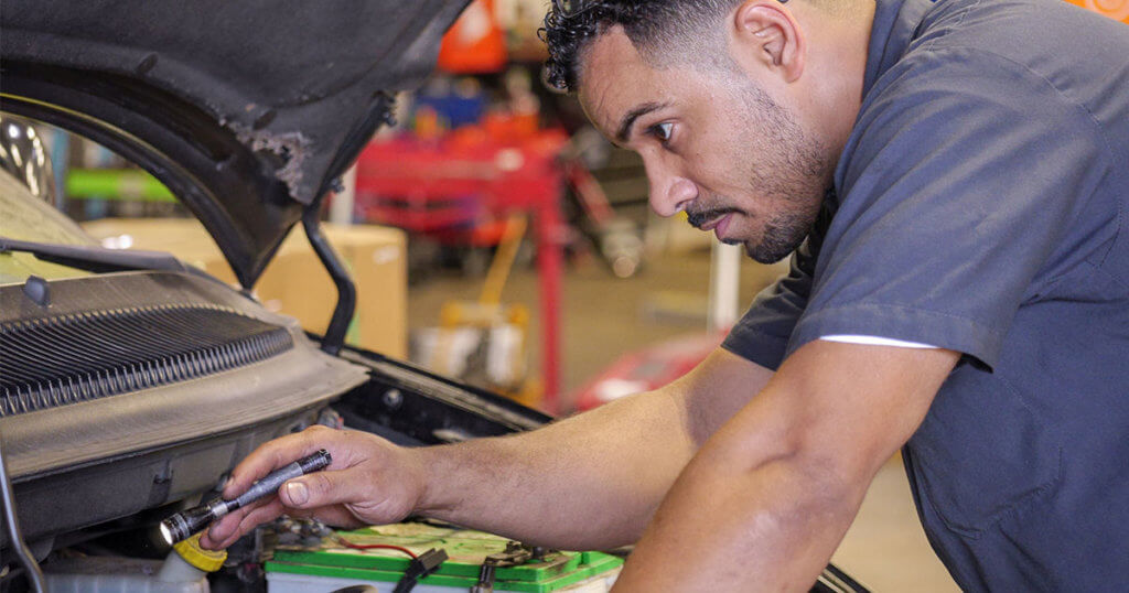MobilityWorks mechanic inspects under hood of vehicle