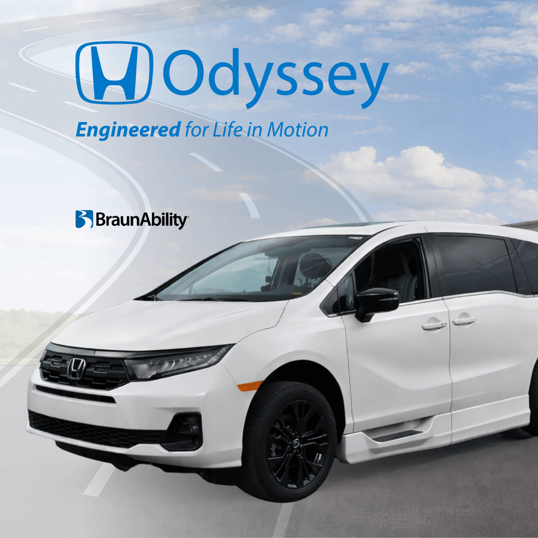 White Honda Odyssey minivan with BraunAbility logo, parked on a road beneath a cloudy blue sky. Text reads Odyssey. Engineered for Life in Motion. Discover MobilityWorks promotions for added value and accessibility.