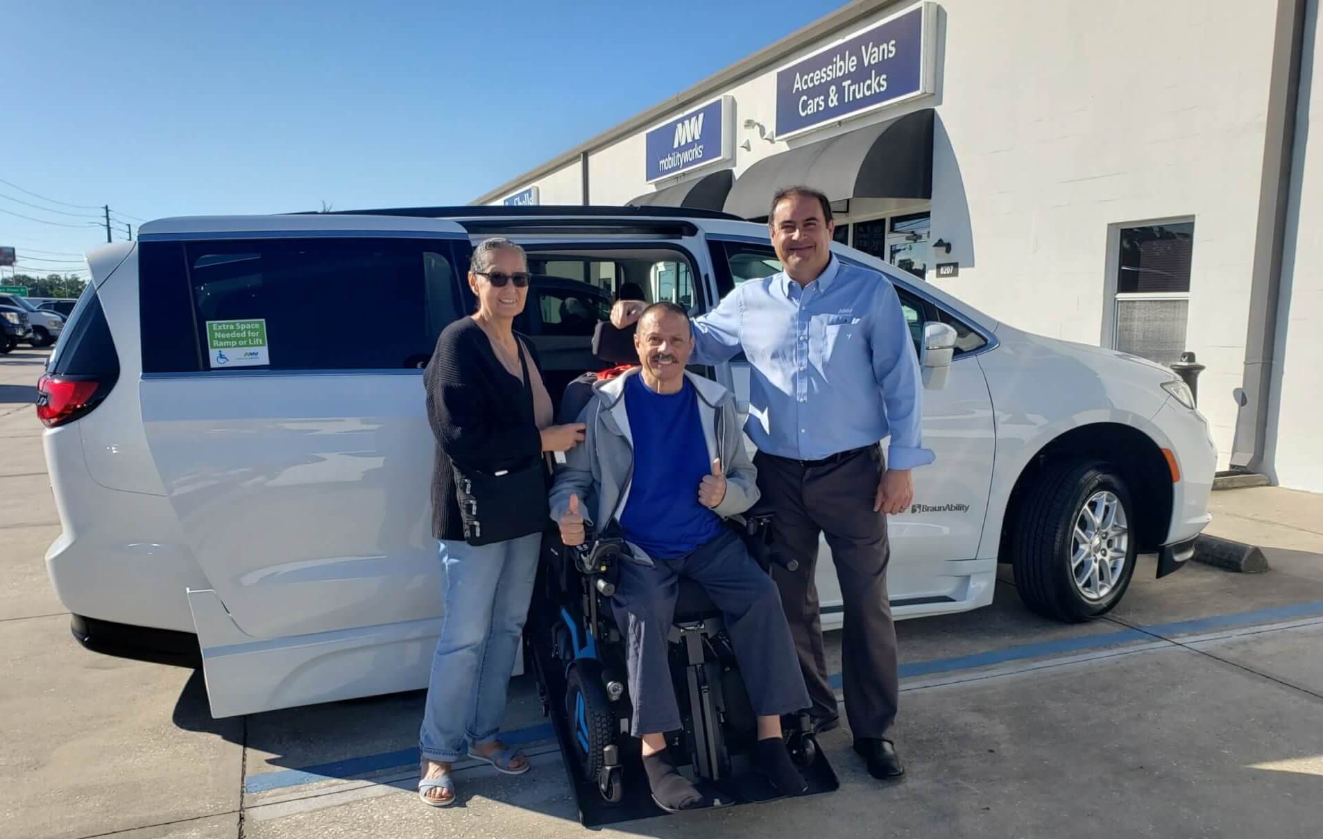 Paul with some happy customers in front of a new van.