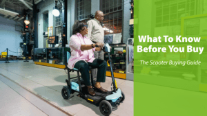 An older woman rides a mobility scooter indoors while a man stands beside her; text overlay reads, What To Know Before You Buy - The Scooter Buying Guide.