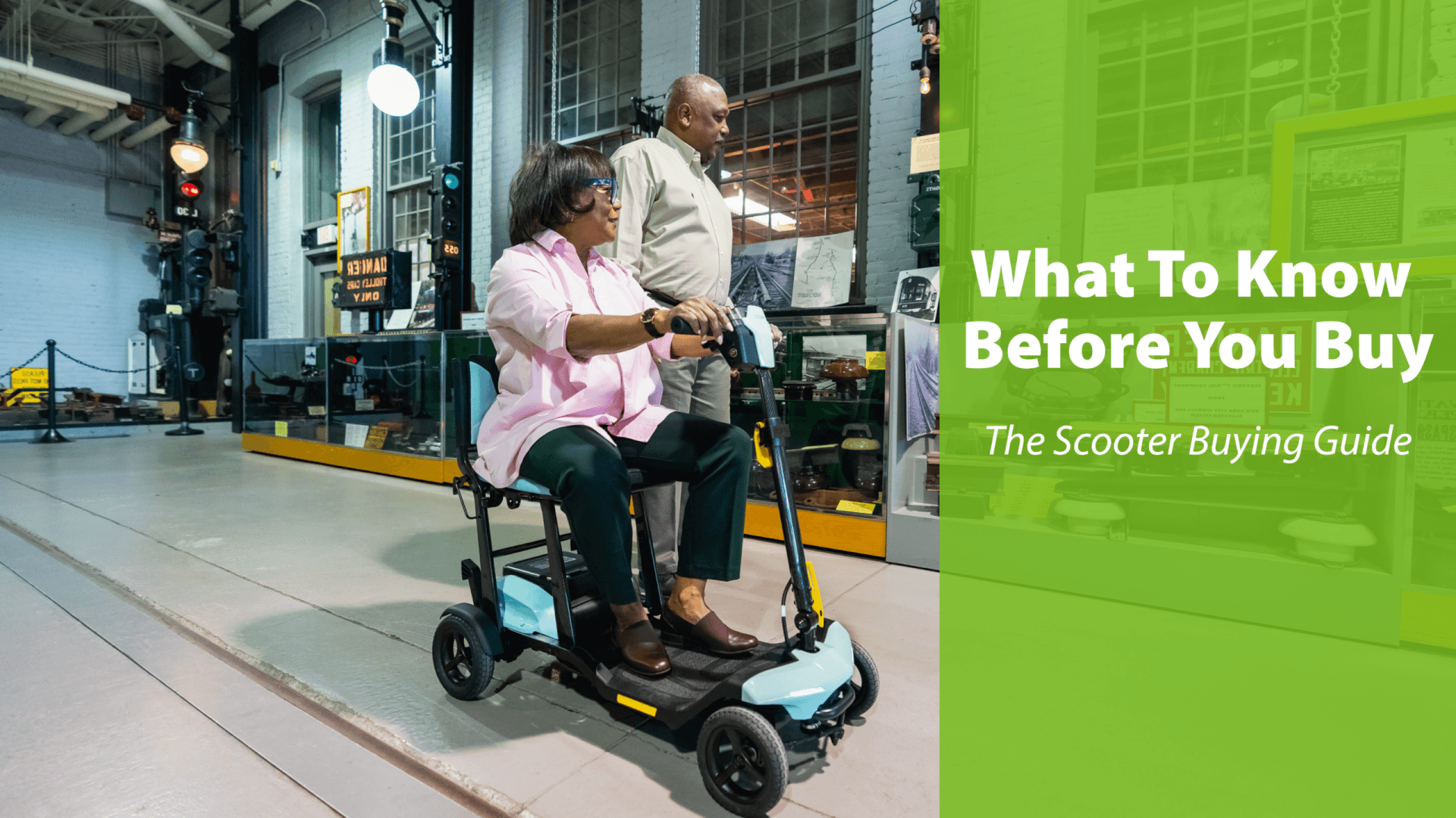 An older woman rides a mobility scooter indoors while a man stands beside her; text overlay reads, What To Know Before You Buy - The Scooter Buying Guide.