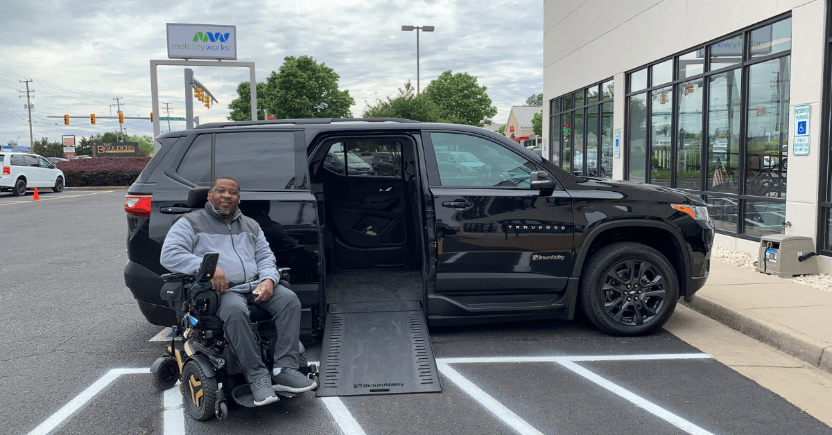 Veteran Randolph Stone, of Virginia, poses next to his accessible Chevrolet Traverse