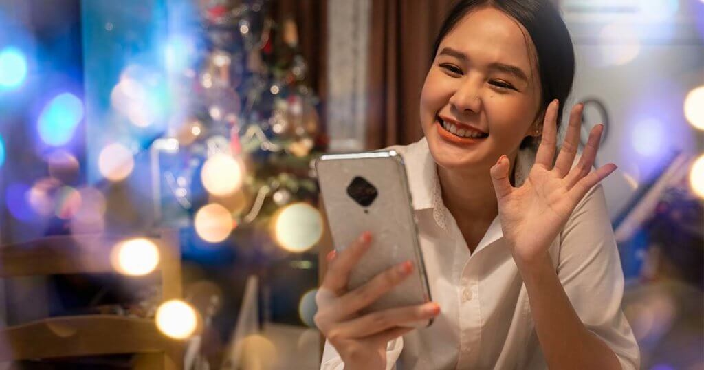 Woman video chats with loved ones during the holidays.