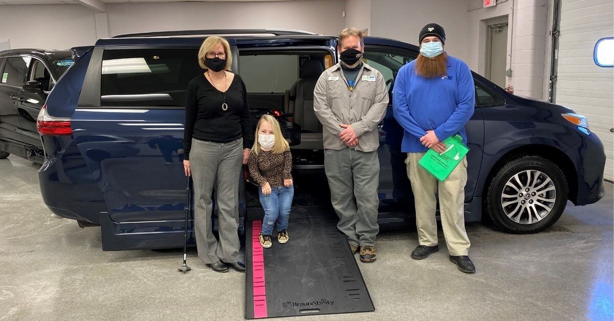 Megan stands next to her new accessible van