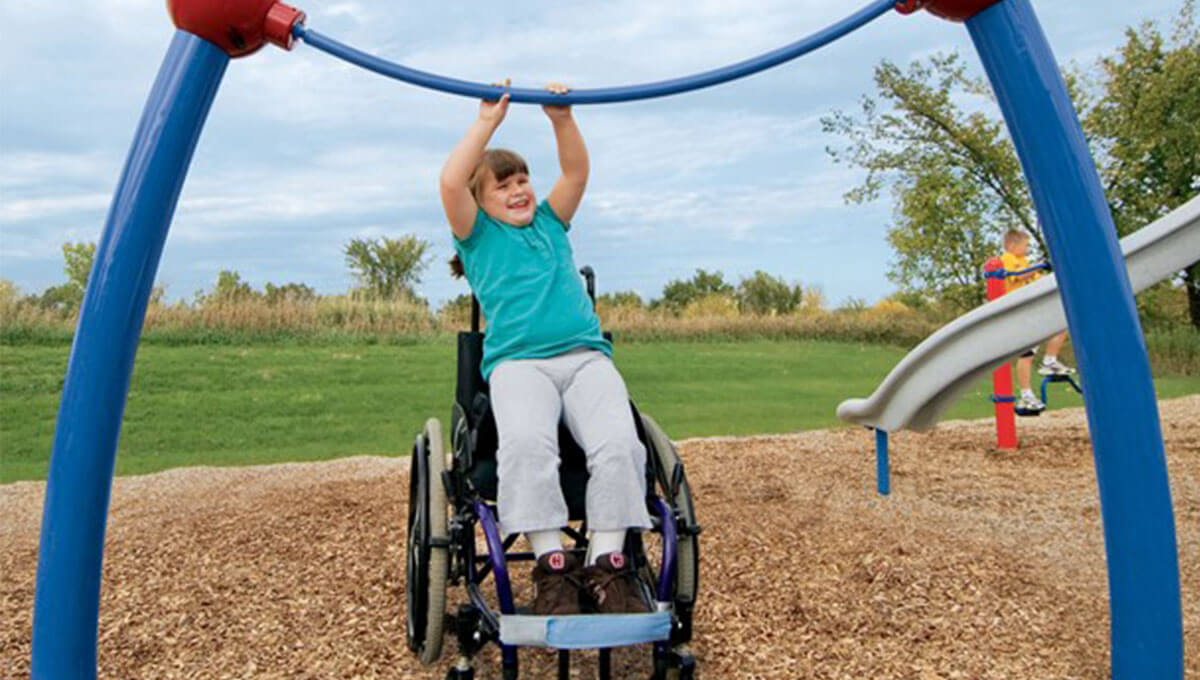 Girl plays on accessible chin up bar