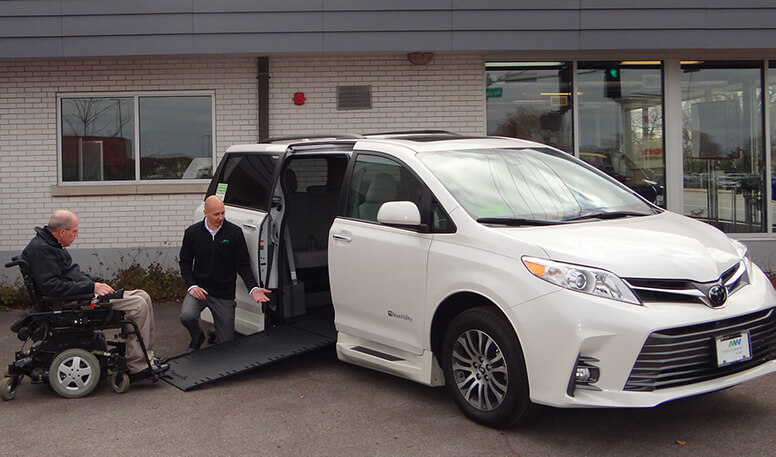 mobilityworks team member shows the ramp operation of a wheelchair accessible vehicle