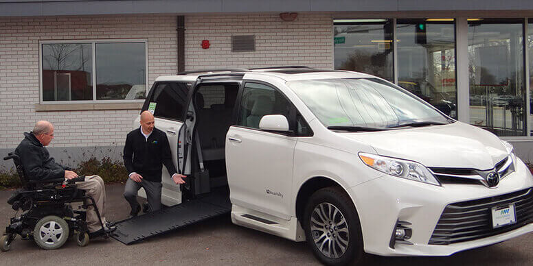 mobilityworks team member shows the ramp operation of a wheelchair accessible vehicle