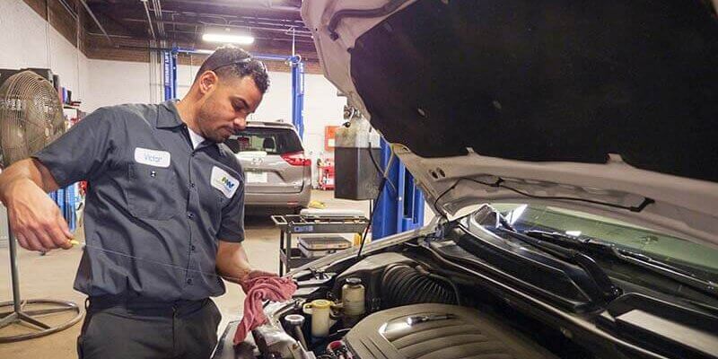 Service Tech checking oil of vehicle