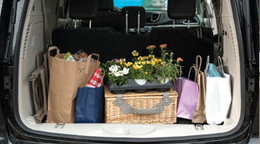 Wheelchair cargo space with backpack, cooler, and brown paper 