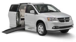 Smaller image of side entry gray Dodge caravan with Braunability logo on the passenger side door 