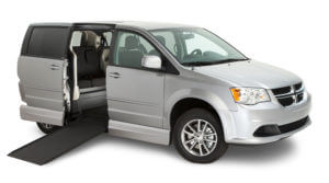 Clean silver Dodge Northstar wheelchair van with a wheelchair ramp.