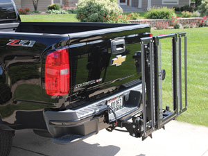 Out-Sider folded on back of black pickup truck