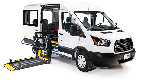 White full-size conversion van with a wheelchair lift installed in the left side entryway