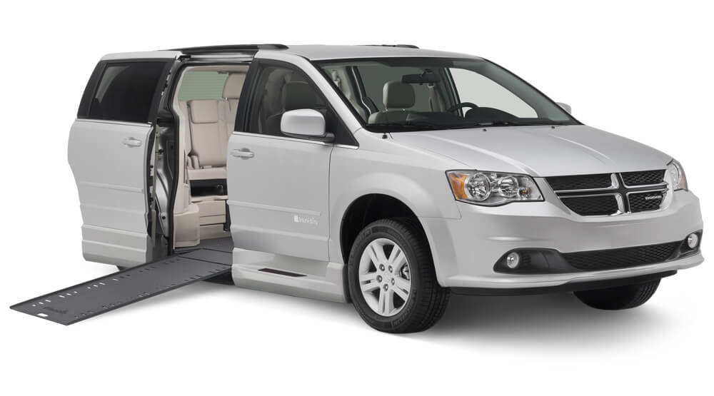 Gray Dodge wheelchair van with slightly elevated ramp and side door open
