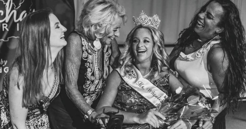Ms. Wheelchair America 2023 Ali Ingersoll posing with other females and smiling