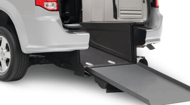 Metal power angle manual ramp attached to a wheelchair van. 