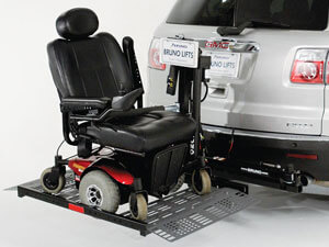 power wheelchair lift on back of silver vehicle