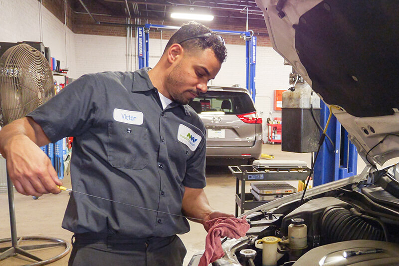 MobilityWorks Service Technician working on vehicle engine