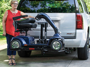 woman with scooter on lift on back of white SUV