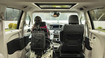 Women sitting on a driver side seat in a wheelchair van with no back seats